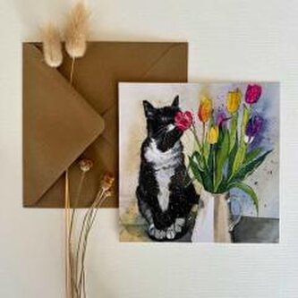 Kot wąchający tulipany